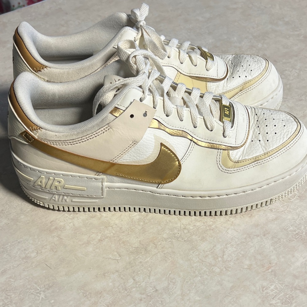 Nike Air Force 1 White and Gold Sneakers